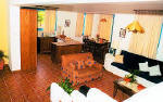 The living room in the foreground and the kitchen and dining room - banana villa near Coral Bay in Cyprus